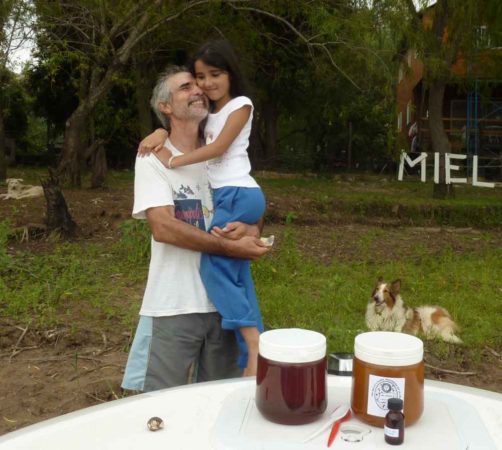 Luis and his daughter pose with the honey